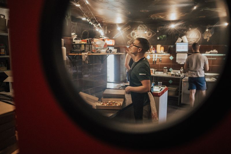 Jet's pizza team members working together in the kitchen